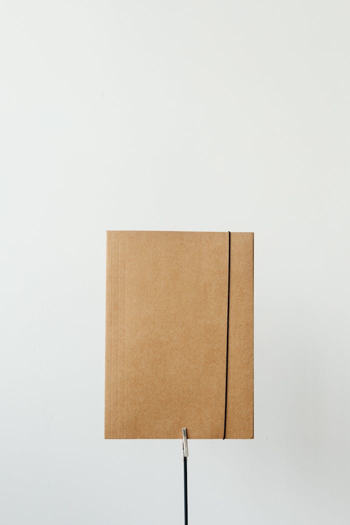 Vertical shot of a cardboard folder against a plain white background for clean, minimalist design.
